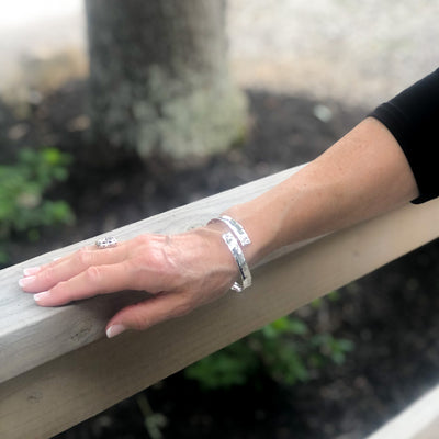 Sterling Bypass Anticlastic Bangle by Judie Raiford on model's hand