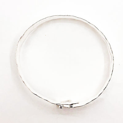 over top view of Sterling Bypass Anticlastic Bangle by Judie Raiford