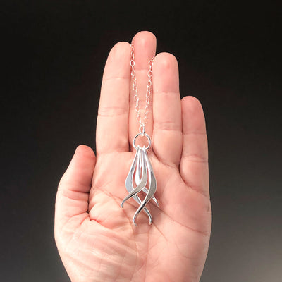 Four Dang Necklace by Judie Raiford held in hand