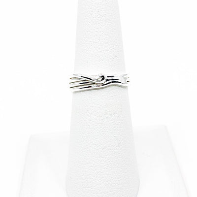 Sterling Random Theory Skinny Ring by Judie Raiford displayed on white ring display stand