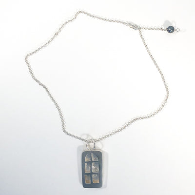 flat lay of Windows of Opportunity Necklace by Ling-Yen Jones