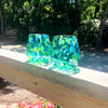 pair of Blue & Green Speckled Wine Tumblers by Nate Nardi  on deck hand rail in outdoor setting