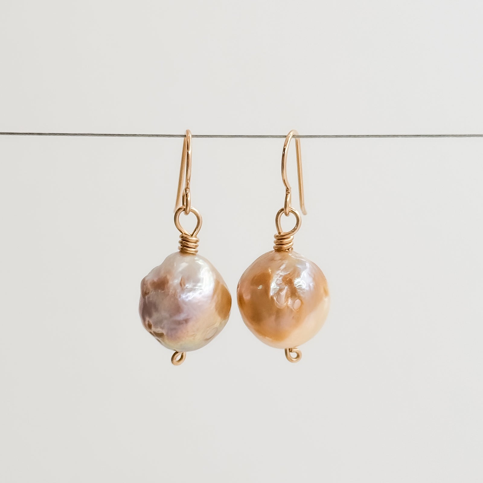 Single large Champagne Baroque pearl earrings