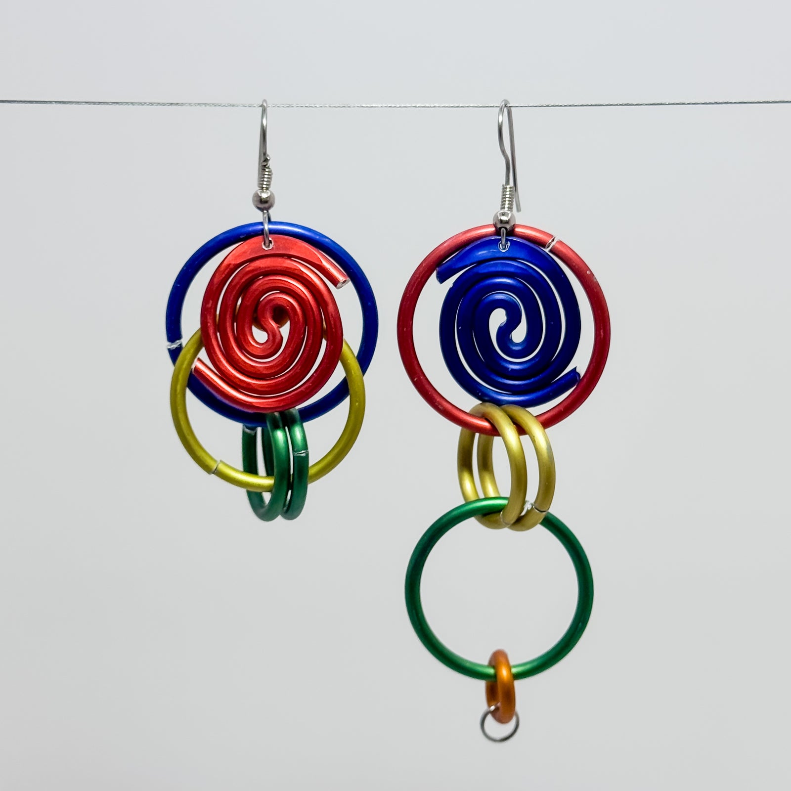 DC5, red, blue, green and gold rings earrings