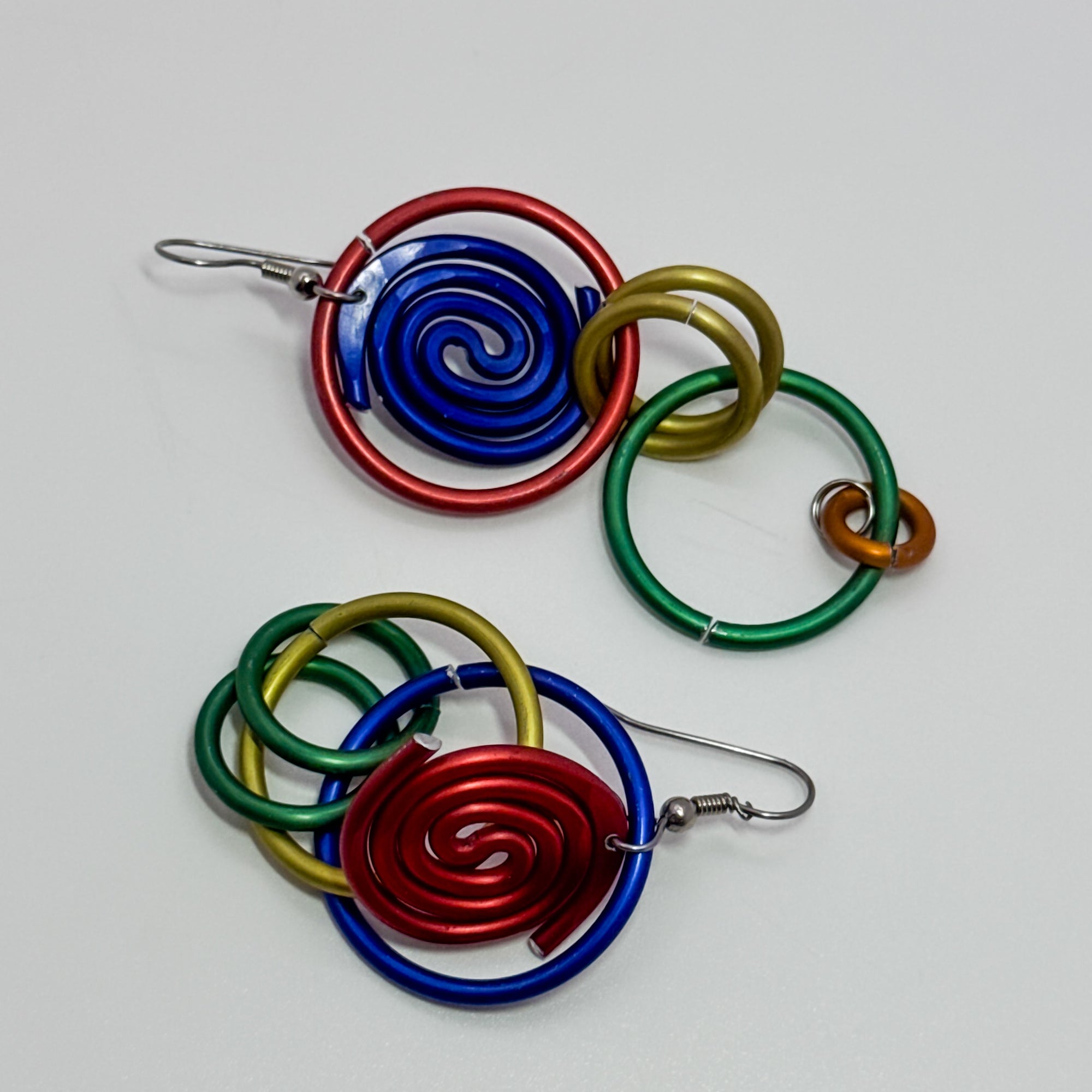 DC5, red, blue, green and gold rings earrings