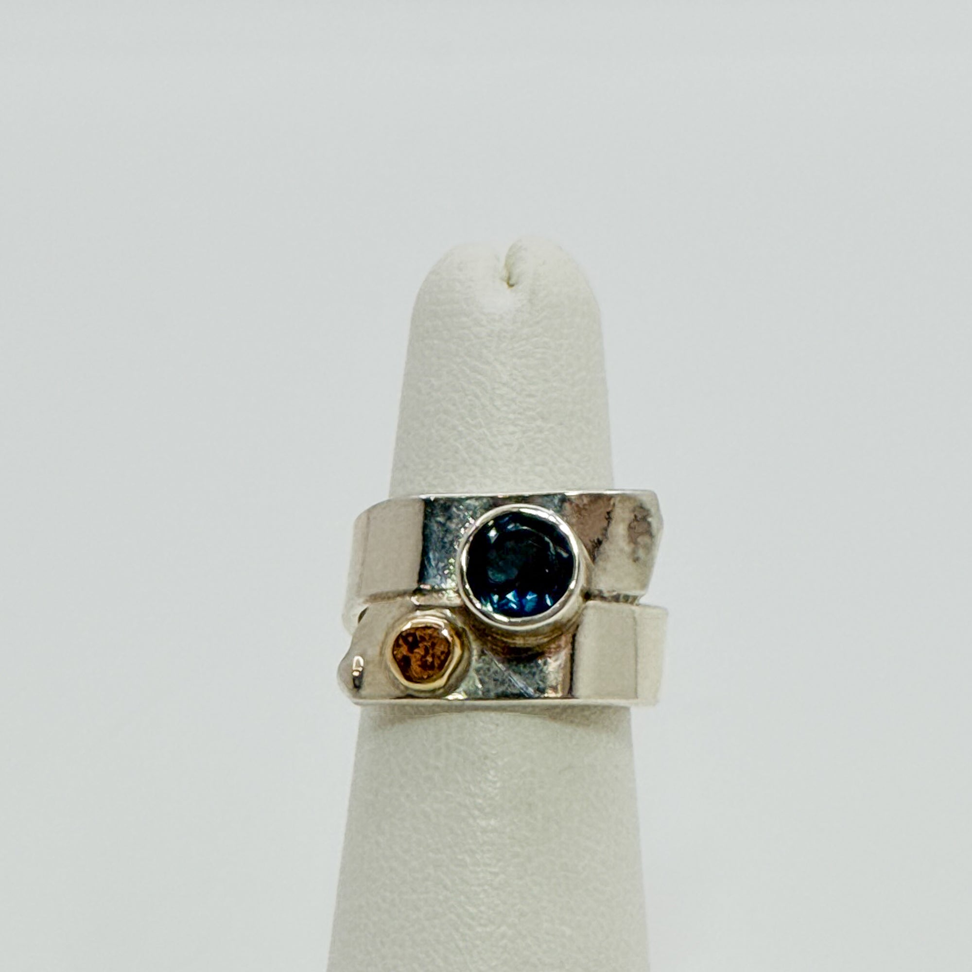 Overlap ring with faceted blue topaz