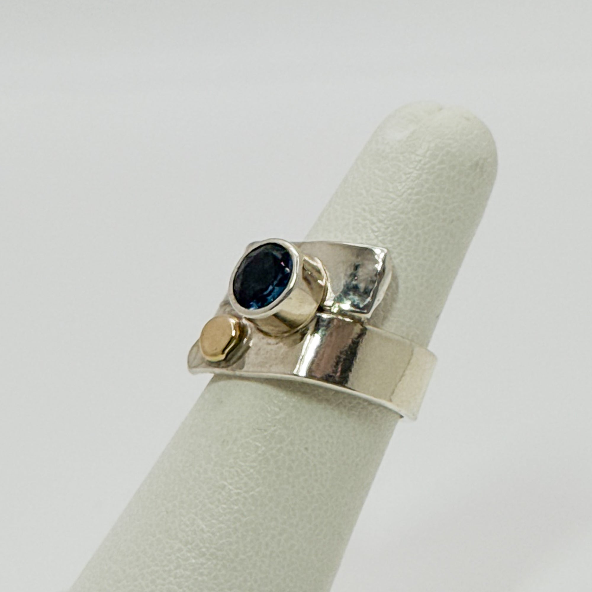 Overlap ring with faceted blue topaz