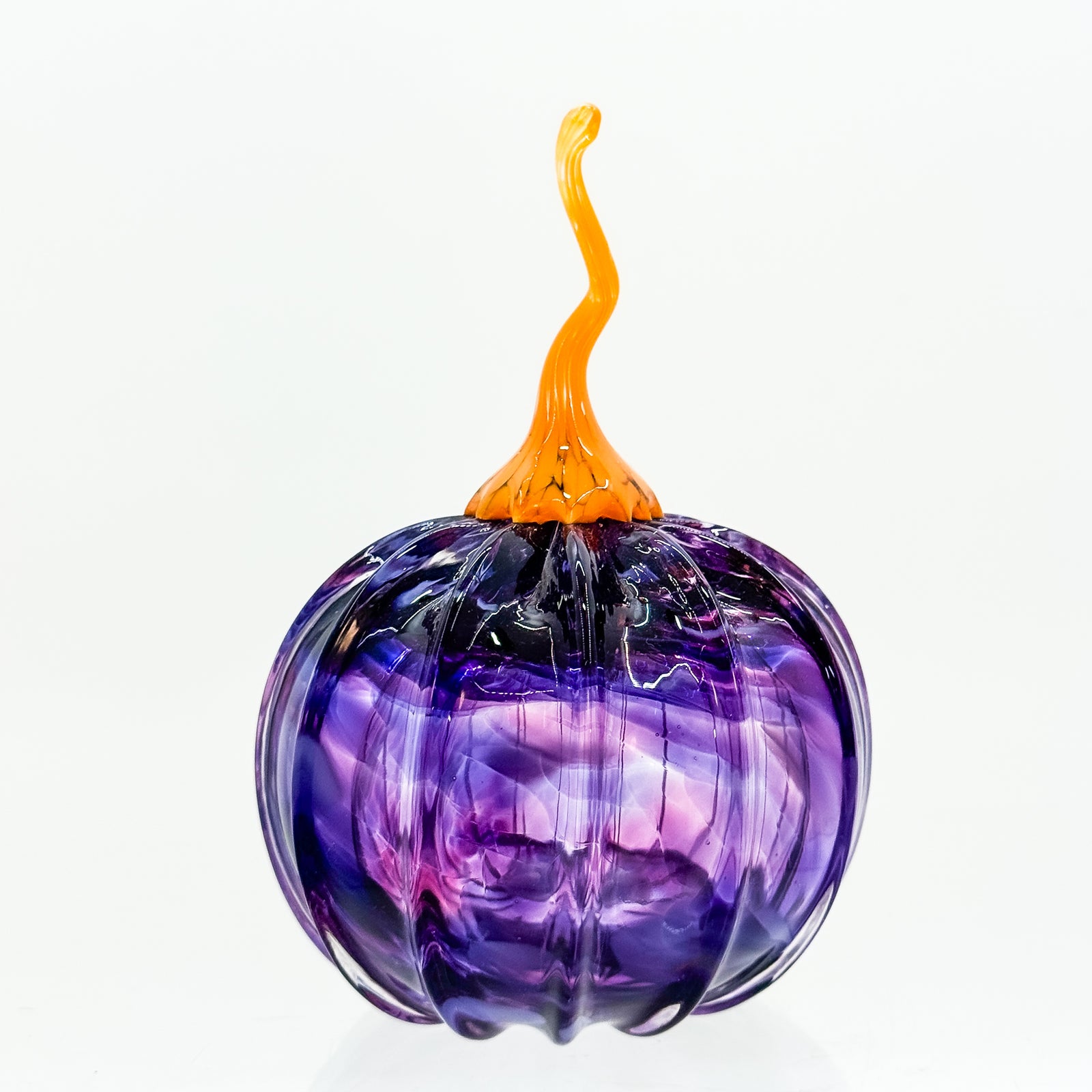 Small round pumpkin in purple with orange stem