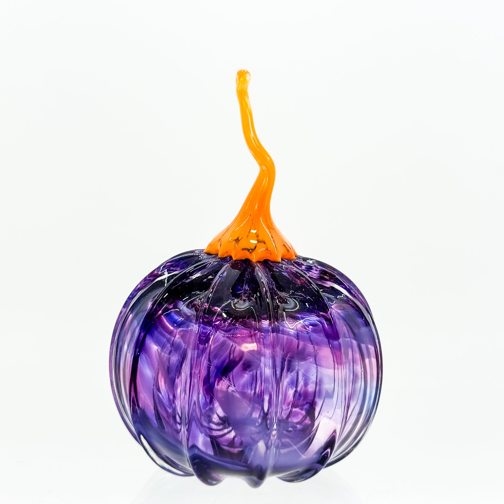 Small round pumpkin in purple with orange stem