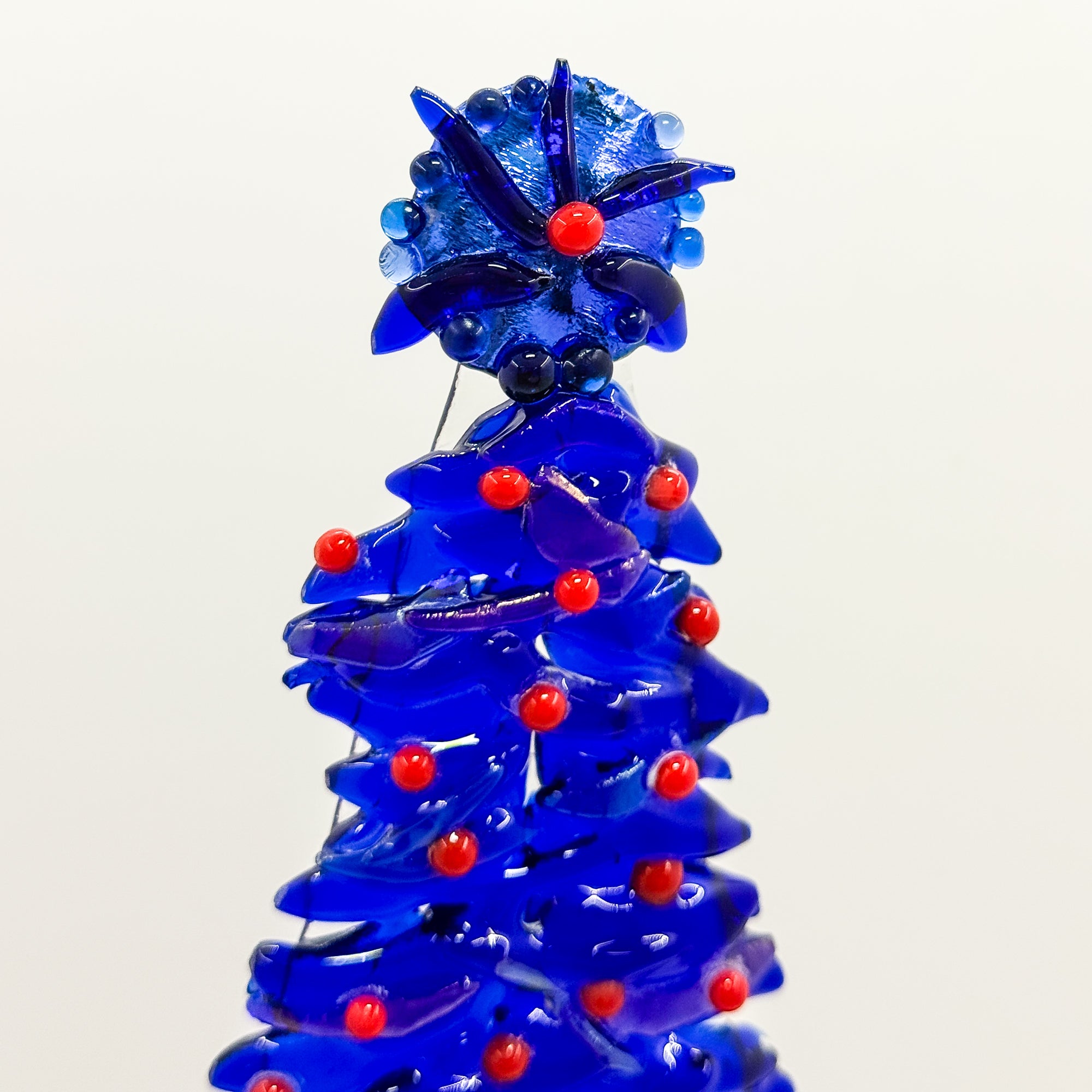 Fused Glass Xmas Tree Candle Holder in dark blue swishes with red dots