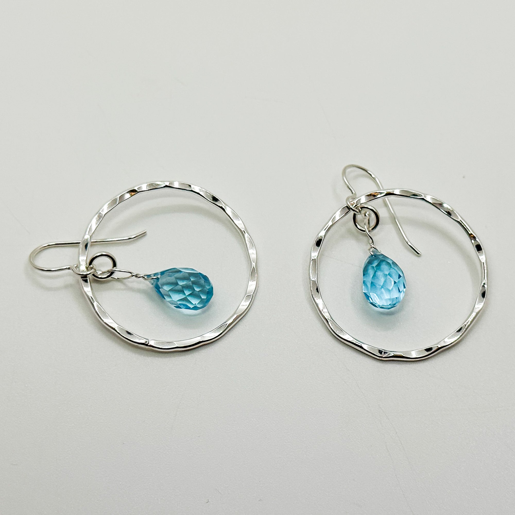 Hoop earrings with topaz drop