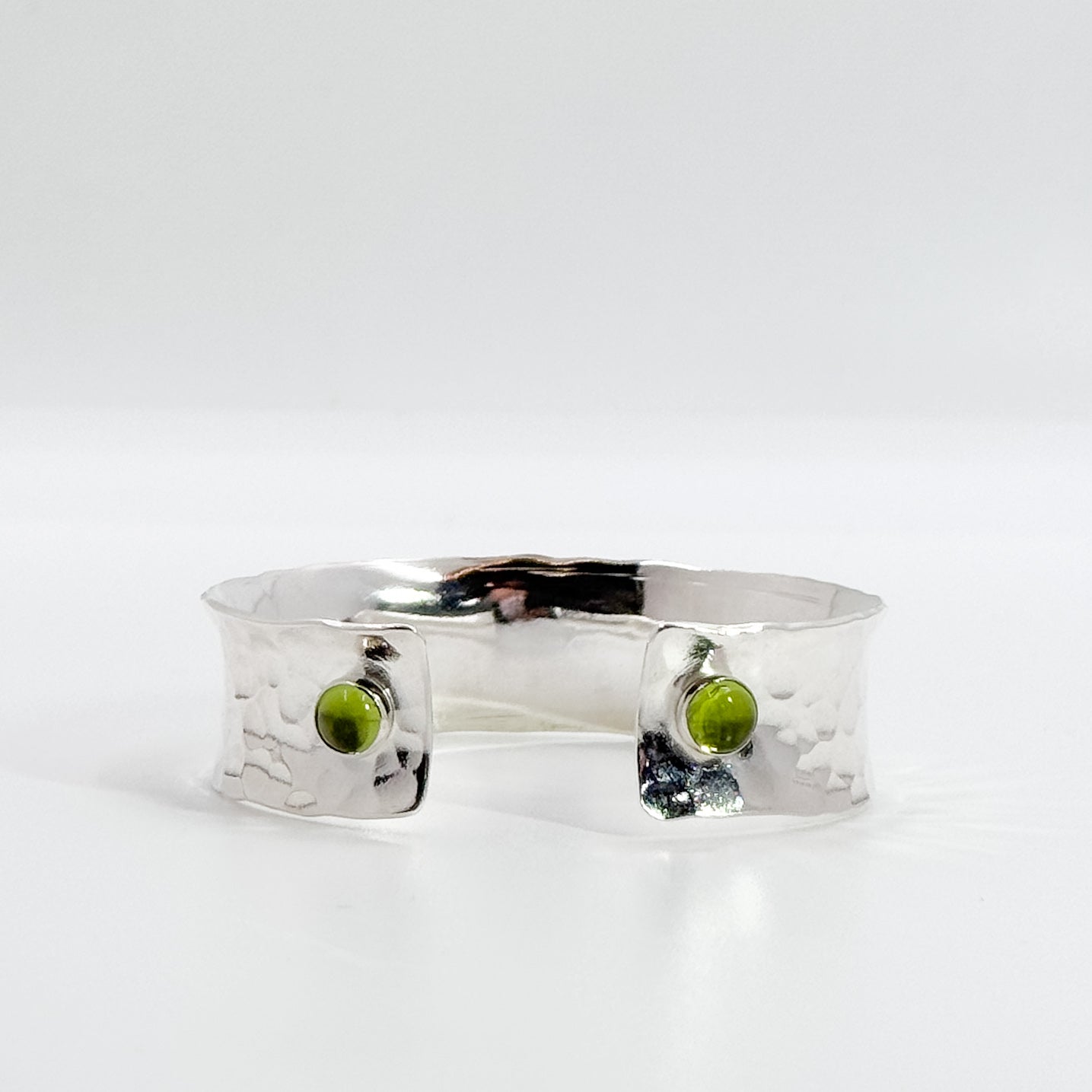 Anticlastic ballpein cuff with peridot cabochon