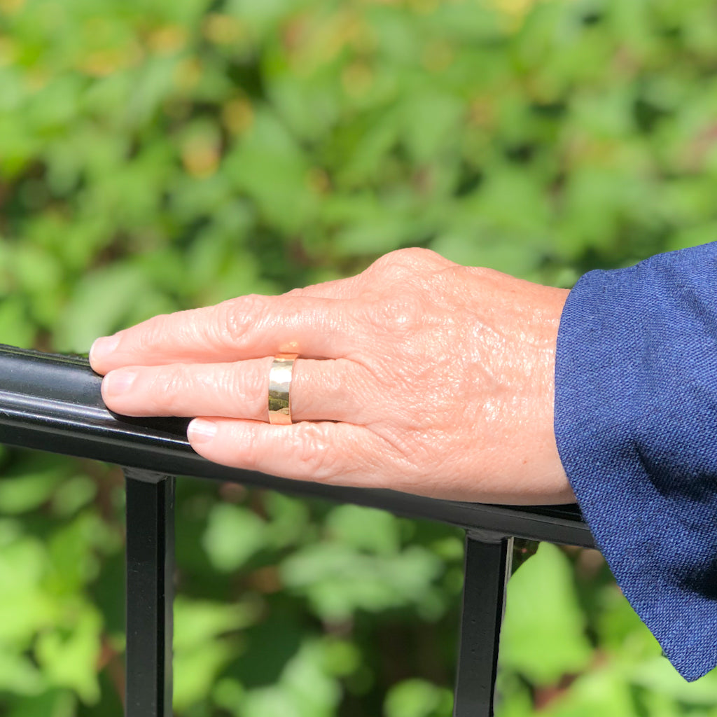 8mm 14k Gold Hammered Band in size 8 by Judie Raiford worn on a model