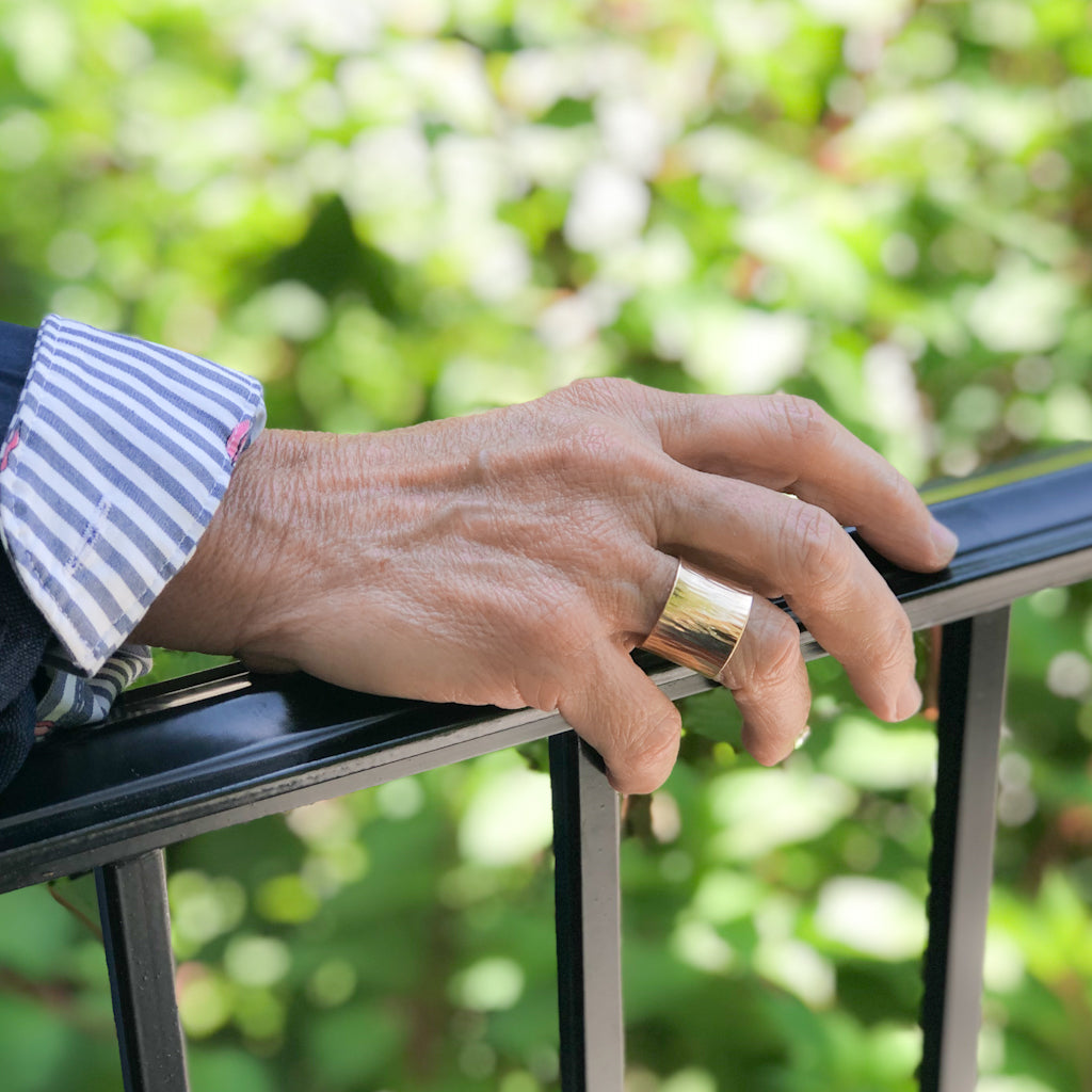 14k Gold Wide Hammered Band by Judie Raiford worn on model
