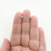 4mm Turquoise Studs by Judie Raiford held in hand