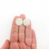 sterling silver Corrugated Series Disc Earrings by Judie Raiford held in hand