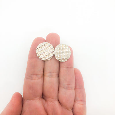sterling silver Corrugated Series Disc Earrings by Judie Raiford held in hand
