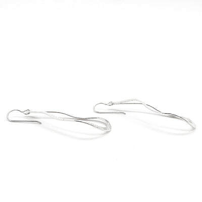 side angle view of sterling silver Textured Pear Drop Earrings by Judie Raiford