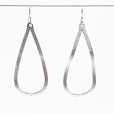sterling silver Textured Pear Drop Earrings by Judie Raiford hanging on wire