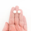 Extra Large 12mm White Pearl Stud Earrings by Judie Raiford held in hand