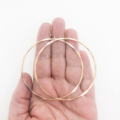 14k Gold Filled Large Hammered Hoop Earrings by Judie Raiford held in hand