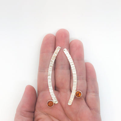 Sterling Silver Long Arched Earrings with Citrine by Judie Raiford held in hand