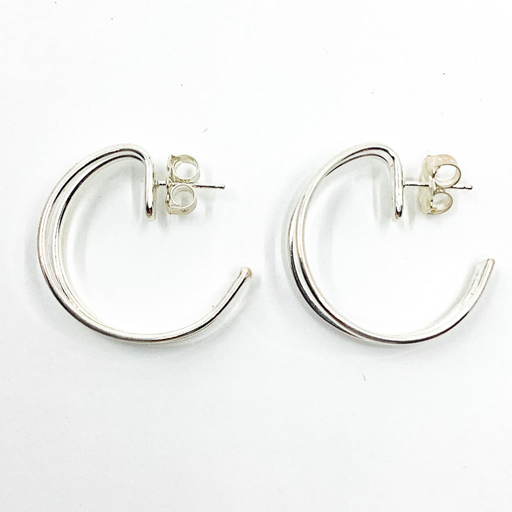 over top view of Sterling Looped End Earrings by Judie Raiford 