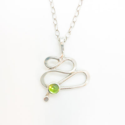 detail of pendant view of sterling silver Touch of Romance Necklace with Peridot by Judie Raiford