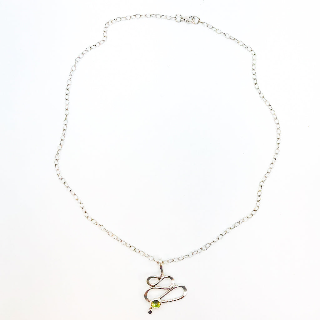 flat lay view of sterling silver Touch of Romance Necklace with Peridot by Judie Raiford