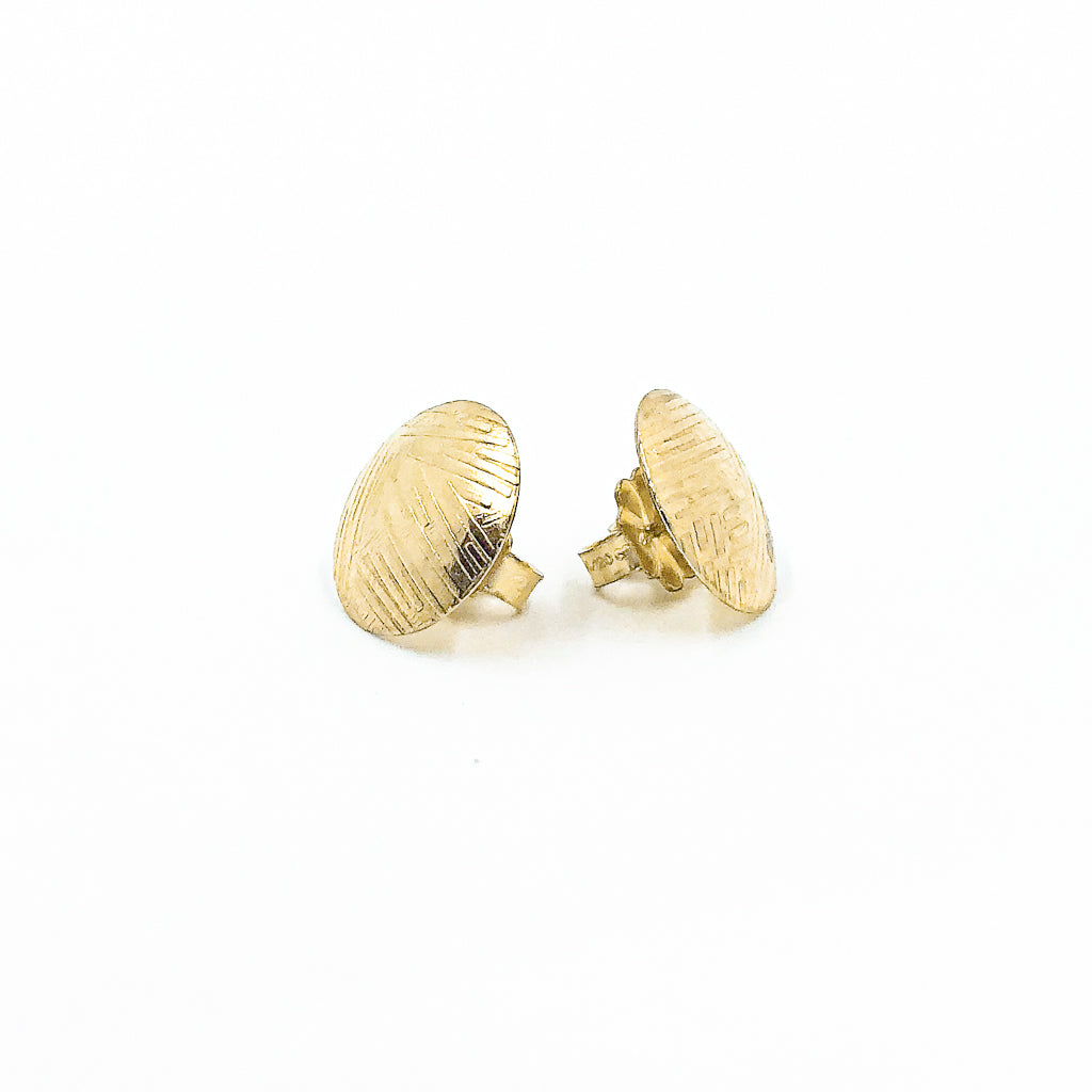 side angle view of 14k Gold Filled Textured Mini Disc Stud Earrings by Judie Raiford