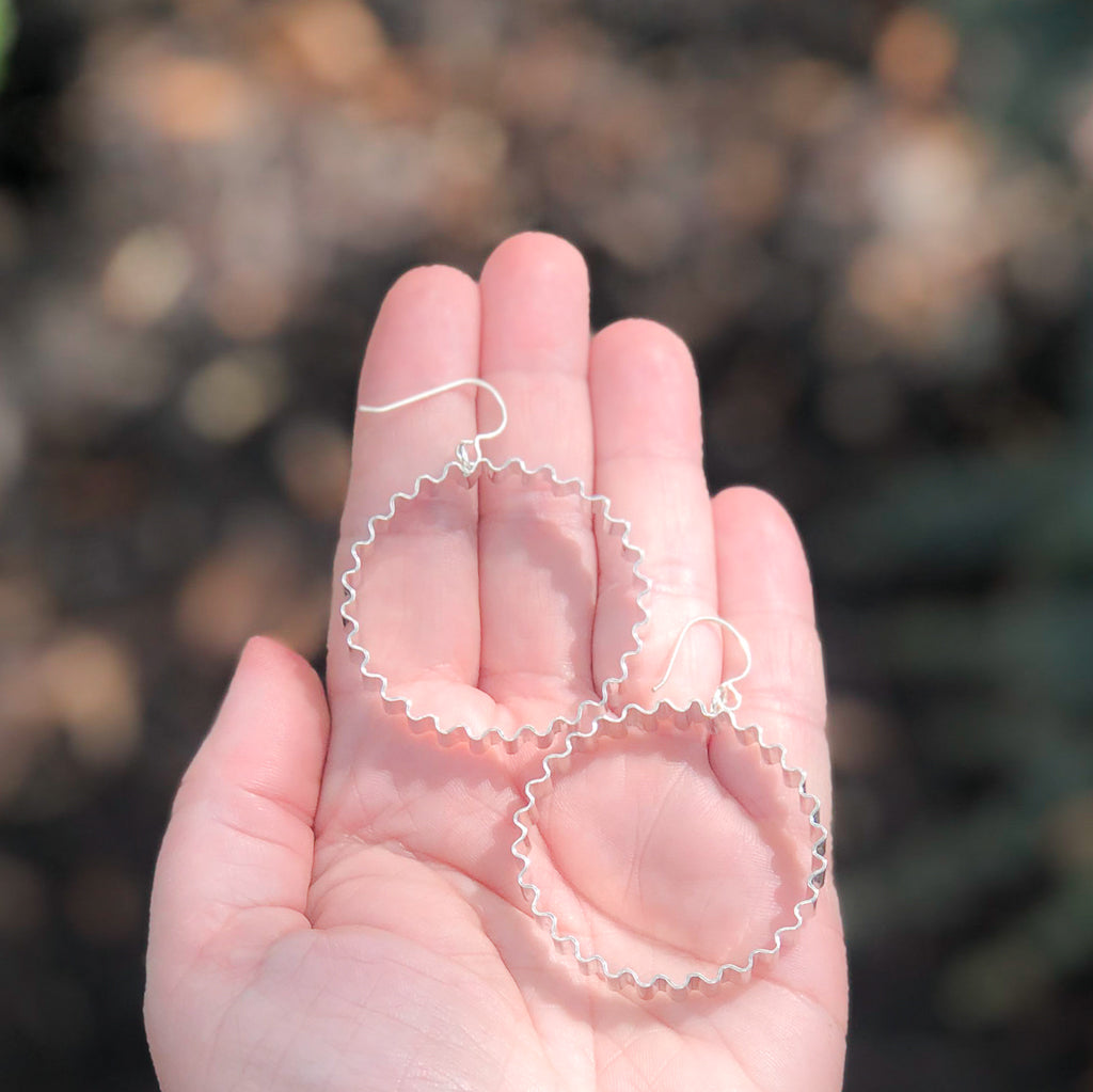 Large Corrugated Hoop Earrings by Judie Raiford held in hand