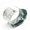 side angle view of 1.5" Oxidized Sterling Wide Anticlastic Cuff by Judie Raiford