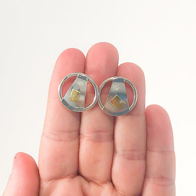 Round Lawa Earrings by Judie Raiford held in hand