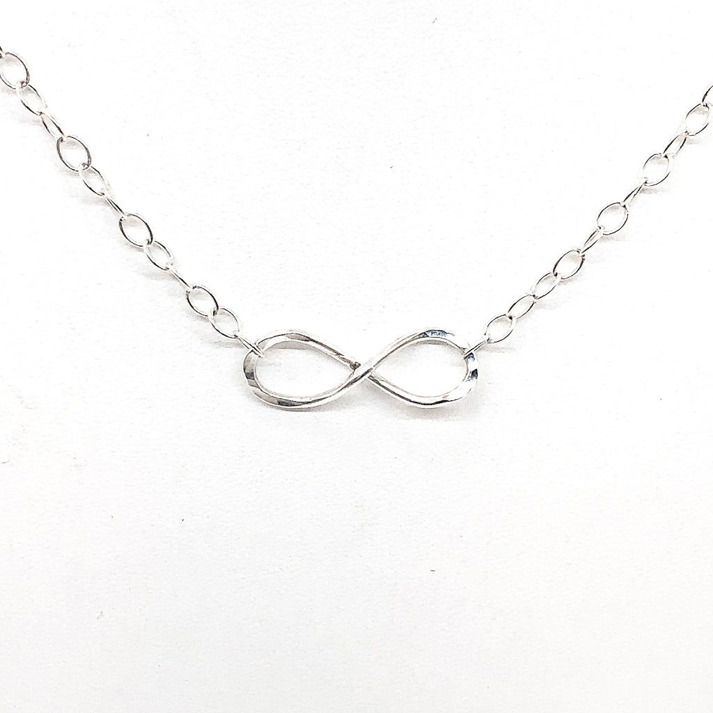 detail view of the pendant on sterling silver Infinity Maggie Necklace by Judie Raiford