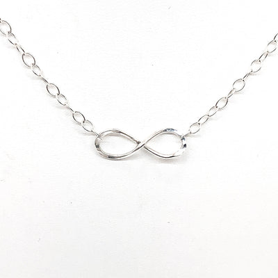 detail view of the pendant on sterling silver Infinity Maggie Necklace by Judie Raiford