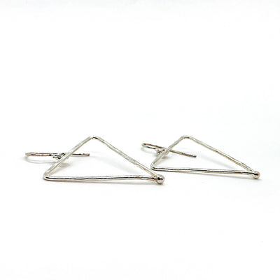 side angle view of sterling silver Short Hammered Triangle Earrings by Judie Raiford