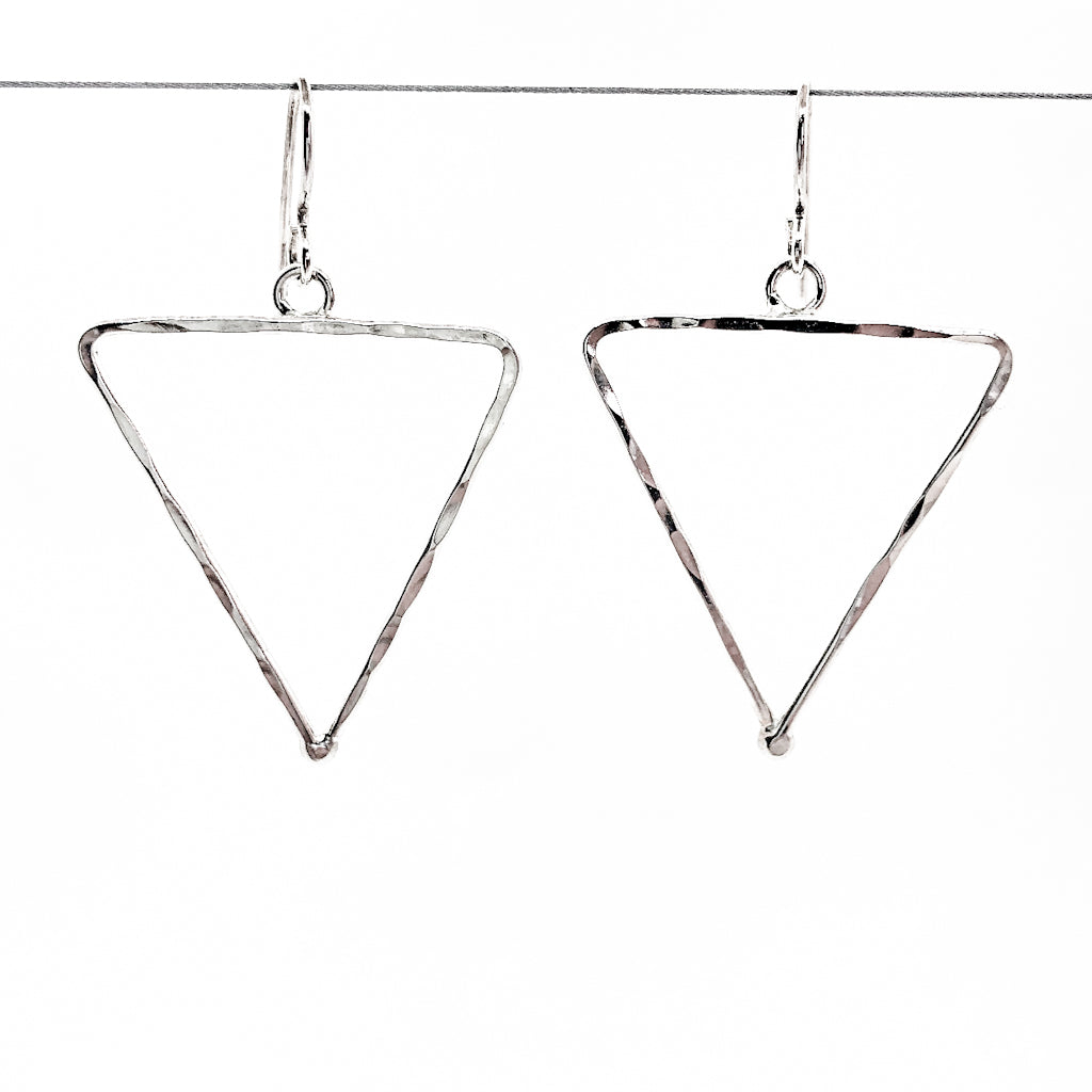 sterling silver Short Hammered Triangle Earrings by Judie Raiford hanging on wire