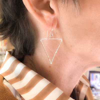 sterling silver Short Hammered Triangle Earrings by Judie Raiford worn on model
