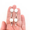 Sterling silver Split Earrings with White Coin Pearl by Judie Raiford held in hand