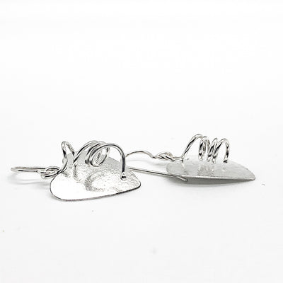 side angle view of Sterling Silver Curly Heart Earrings by Judie Raiford