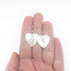 Sterling Silver Curly Heart Earrings by Judie Raiford held in hand