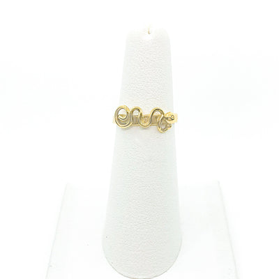 14k Gold Squiggle Ring by Judie Raiford on white ring display stand