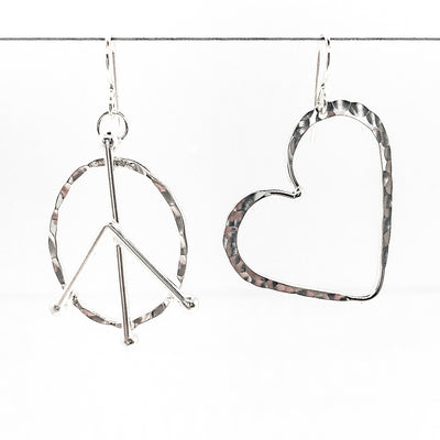 sterling silver Peace and Love Earrings by Judie Raiford hanging on wire