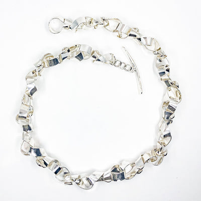 flat lay view of Sterling Davine Necklace by Judie Raiford