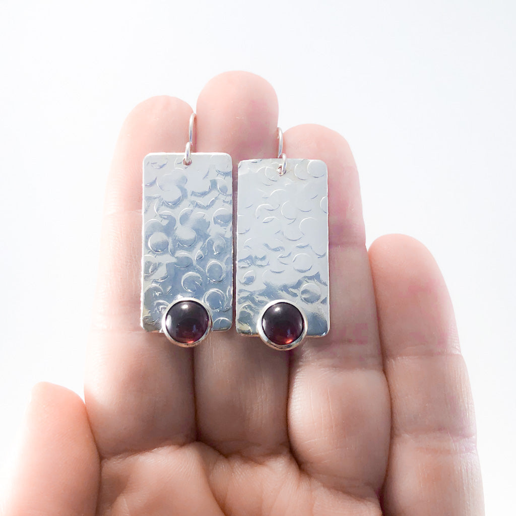 Bubble Up Earrings with Garnet by Judie Raiford held in hand