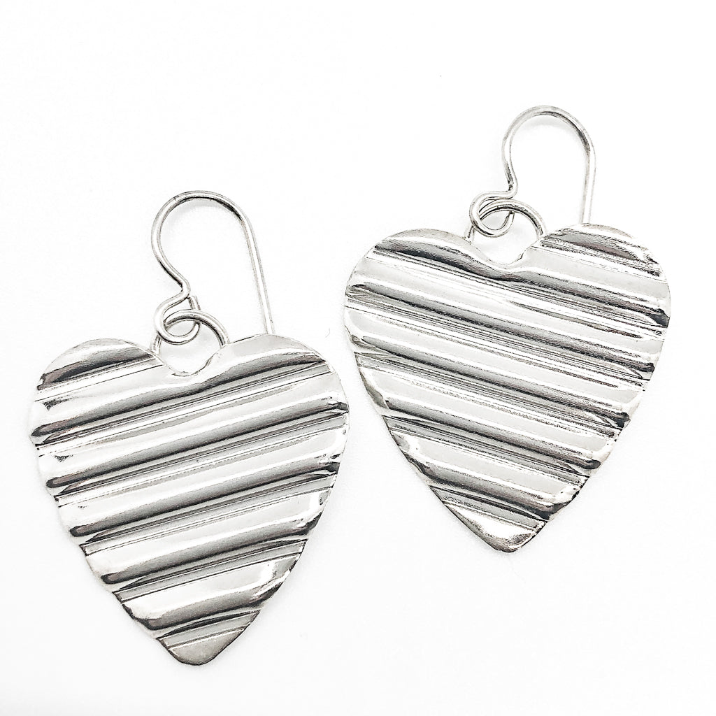 flat lay view of Large Sterling Silver Corrugated Heart Earrings by Judie Raiford