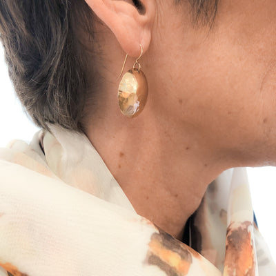 14k Gold Filled Domed Ball Pein Earrings by Judie Raiford worn on a model
