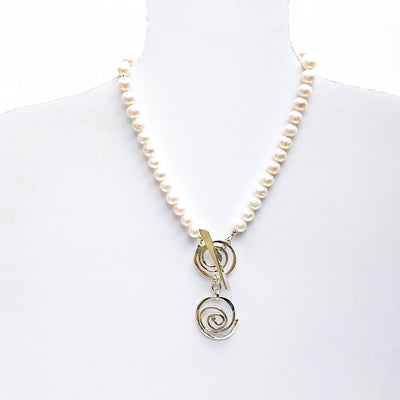 White Pearl Double Swirl Necklace by Judie Raiford on mannequin