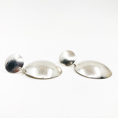 side angle view of Sterling Textured Double Disc Earrings by Judie Raiford
