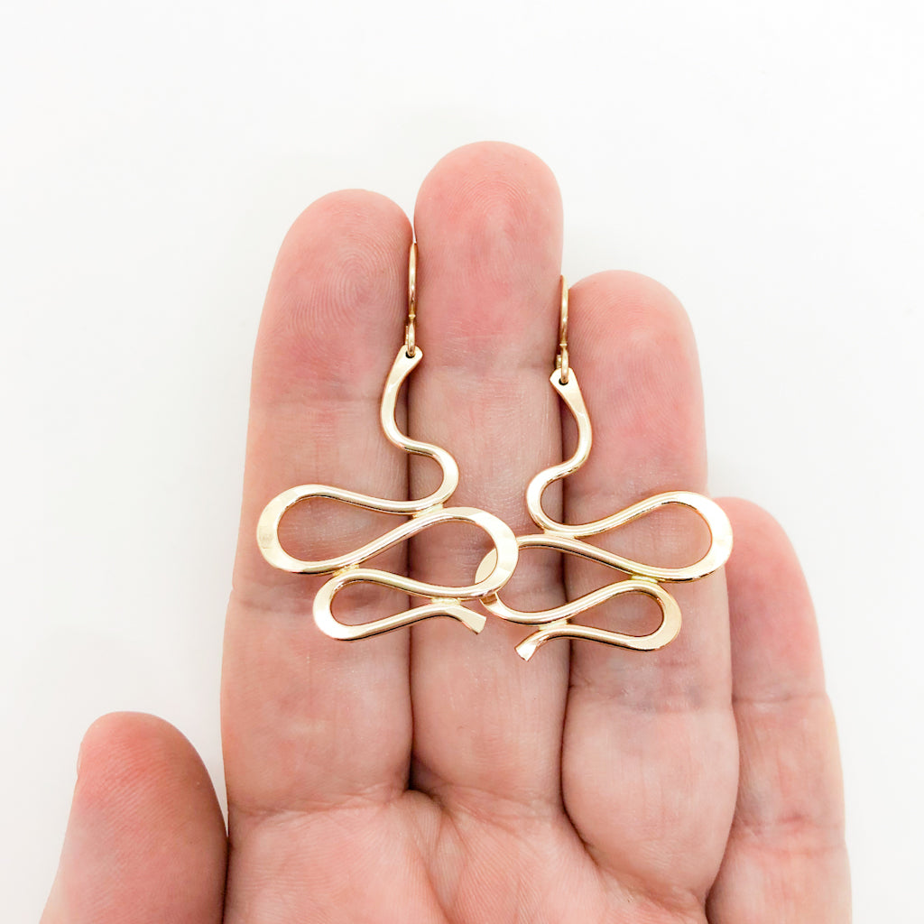 14k Gold Filled Touch of Romance Earrings by Judie Raiford held in hand